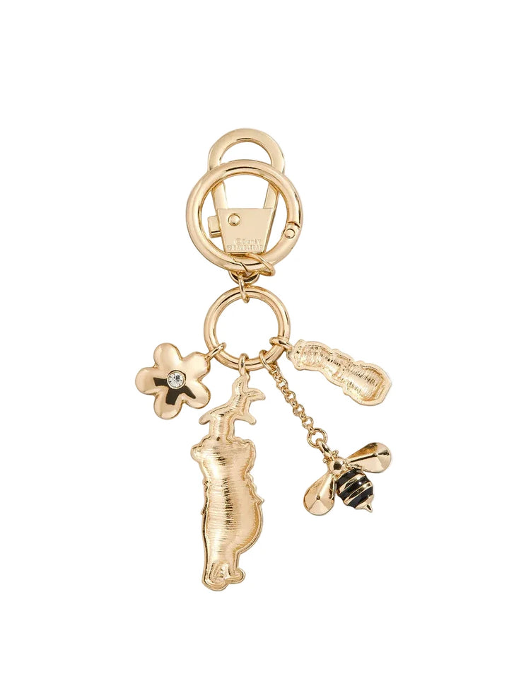 Gold keychain with various charms on a white background