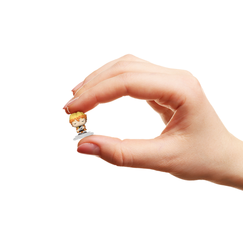 Hand holding a small figurine with a white background