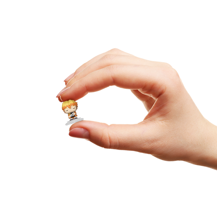 Hand holding a small figurine with a white background