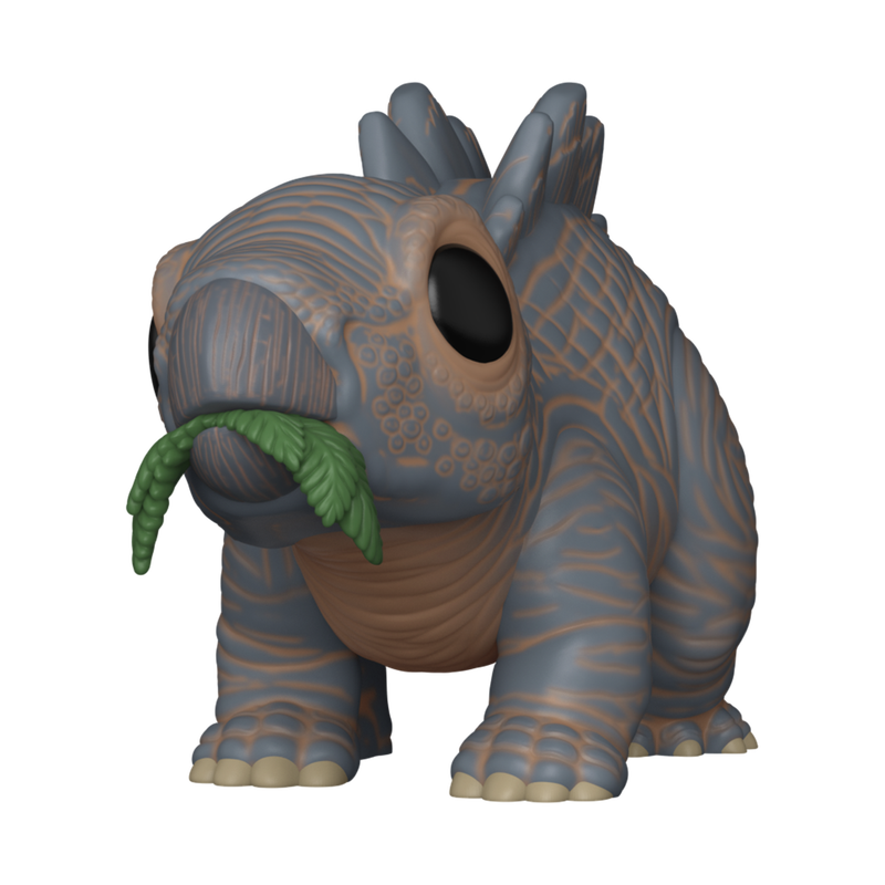 Toy figure of a prehistoric creature with a plant on a white background