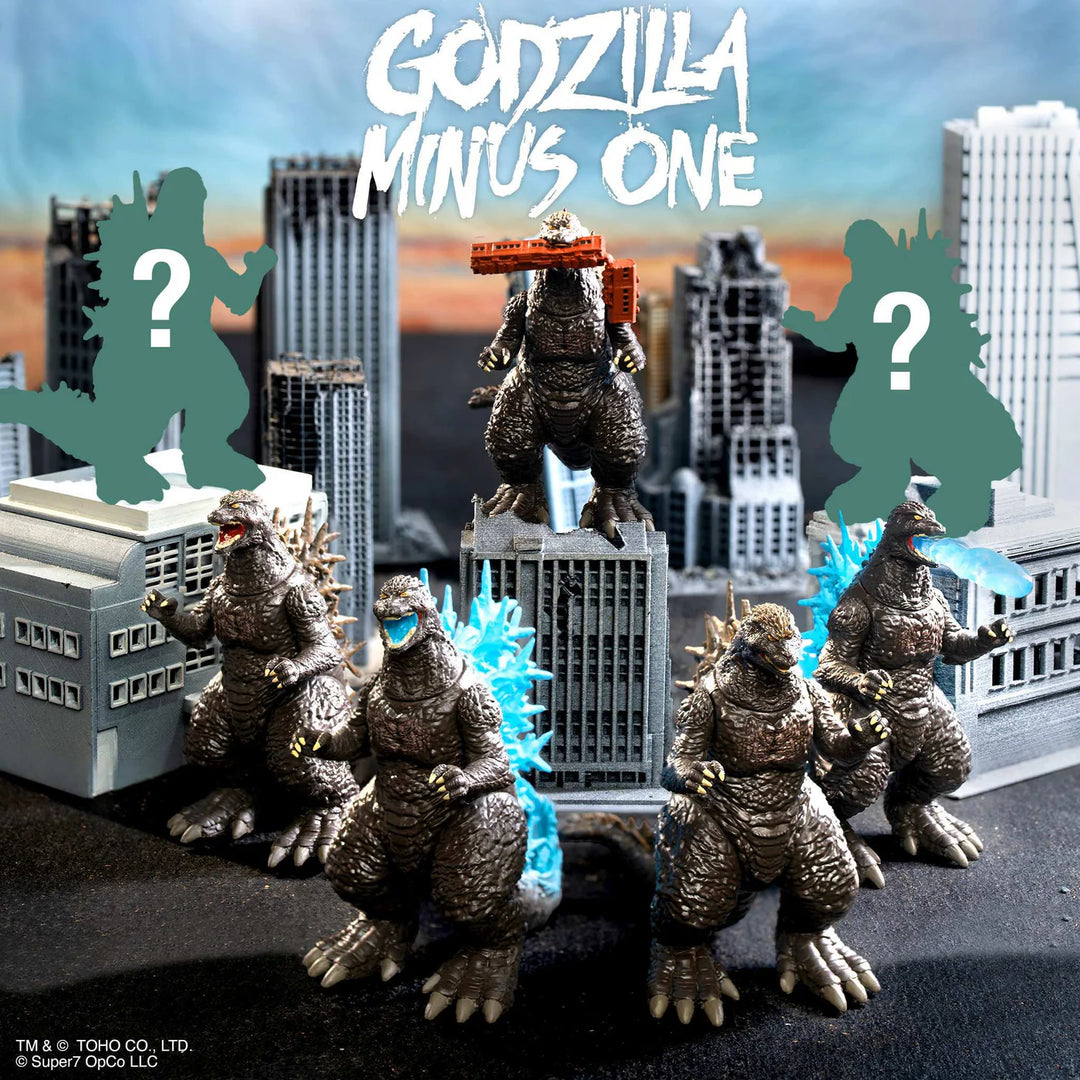 Toy Godzilla figures in front of a cityscape with 'Godzilla Minus One' text.
