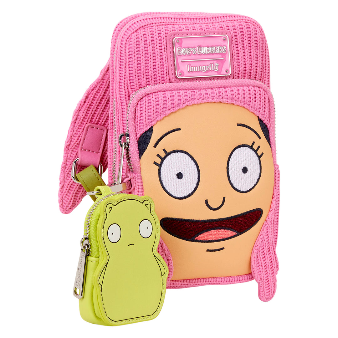 Pink crossbody bag with cartoon character face and green pouch on a white background