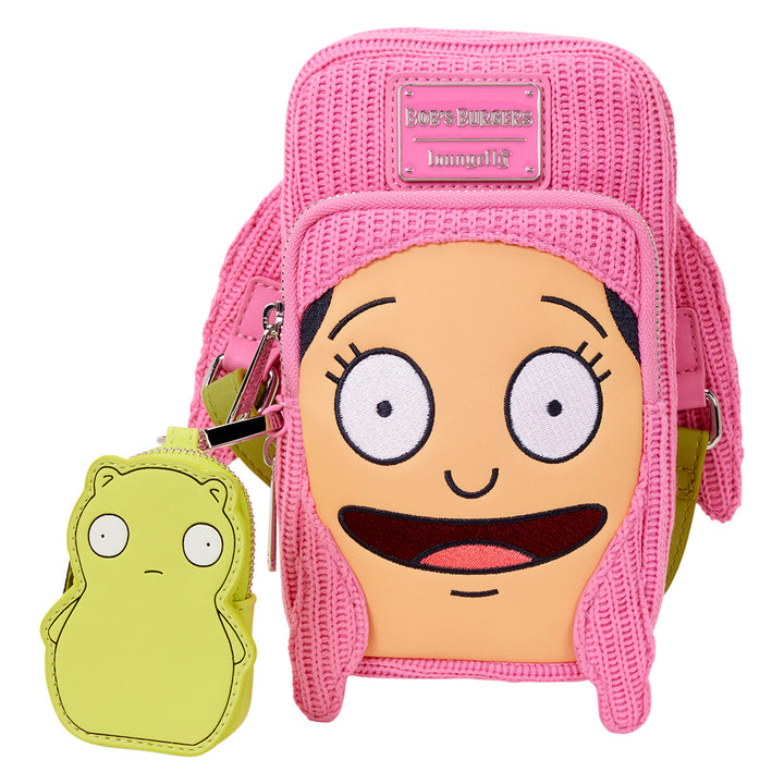 Pink backpack with cartoon face design and small green pouch on a white background