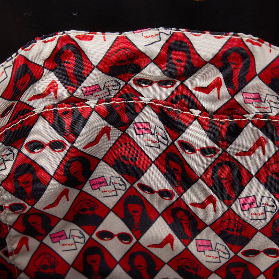 Patterned fabric with red, black, and white design on a dark background