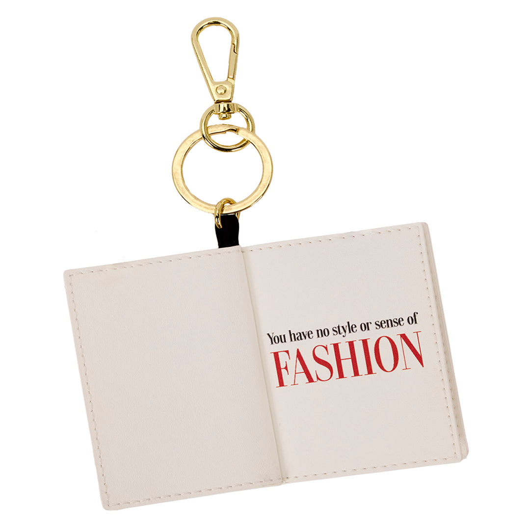 Keychain with open book design and humorous text on a white background