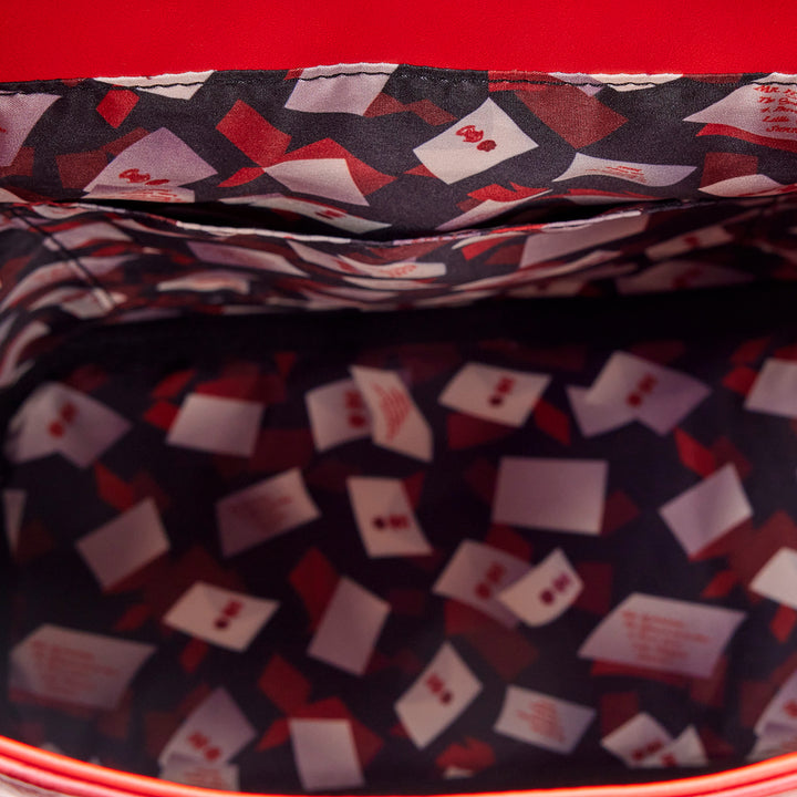 Close-up of a patterned fabric with red, white, and black colors on a red background.