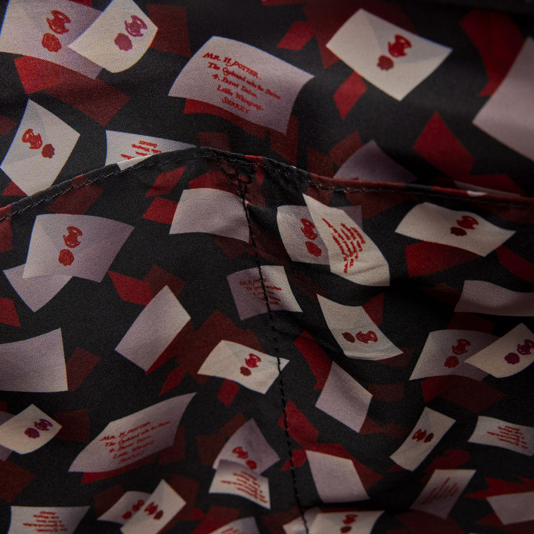 Close-up of a shirt with card pattern and text