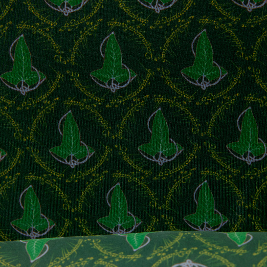 Green fabric with leaf pattern and text on a green background
