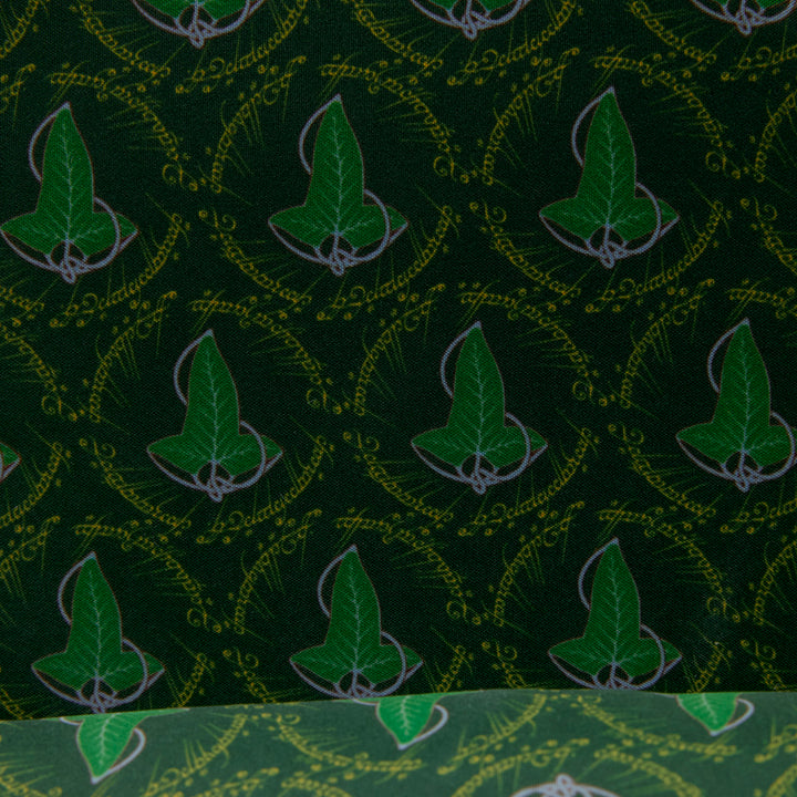 Green fabric with leaf pattern and text on a green background