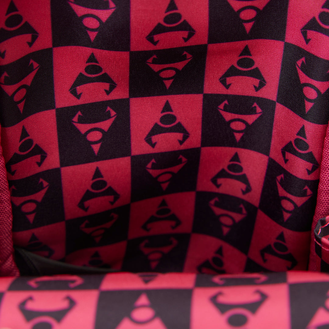 Red and black checkered pattern with geometric shapes on a textured surface.