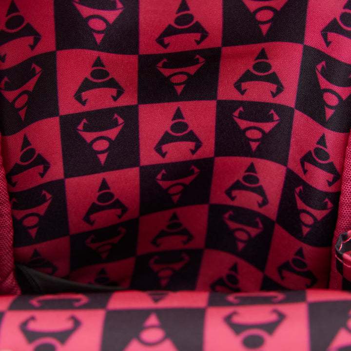 Red and black checkered pattern with geometric shapes on a textured surface.