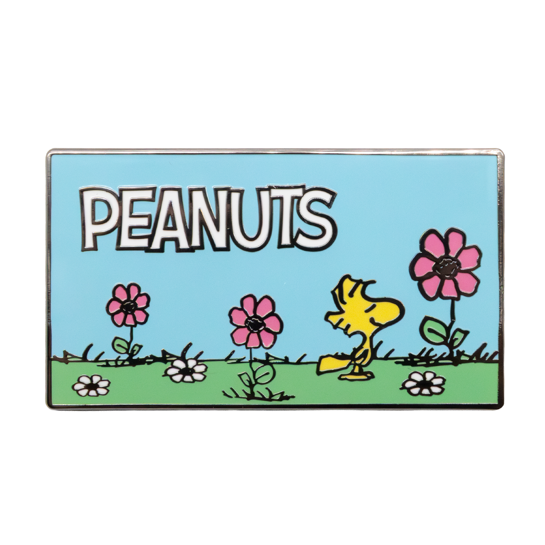 Peanuts-themed badge with a yellow character and flowers on a blue background