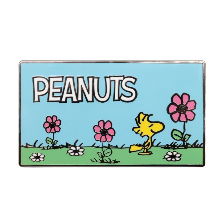 Peanuts-themed badge with a yellow character and flowers on a blue background