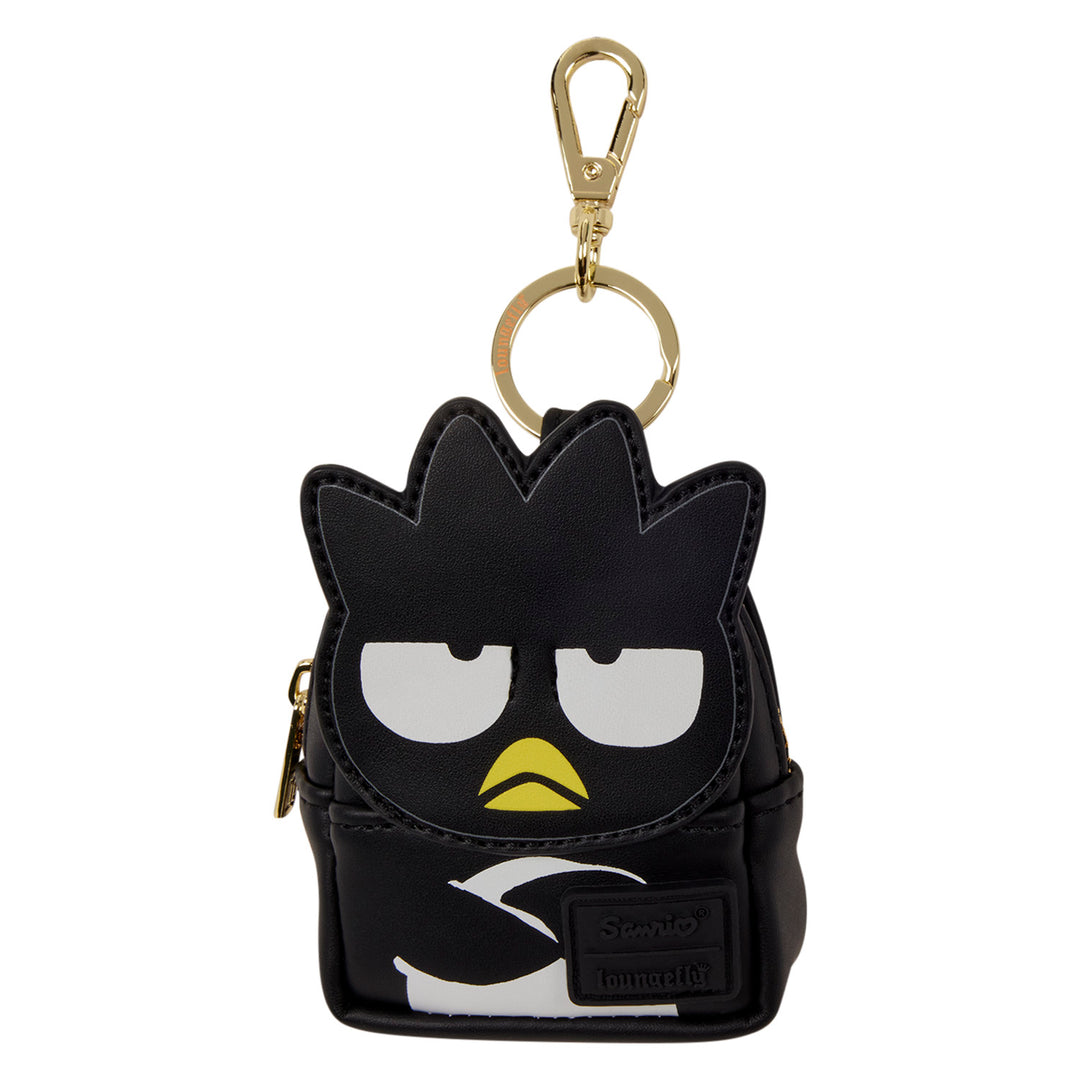 Black character-shaped keychain with a gold clip on a white background