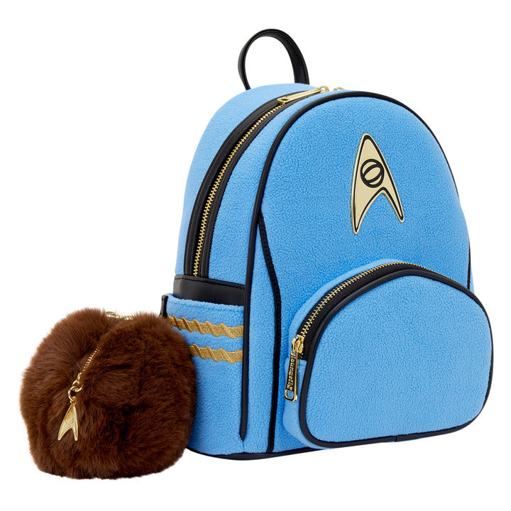 Blue backpack with gold accents and a brown furry pouch featuring a star emblem on a white background