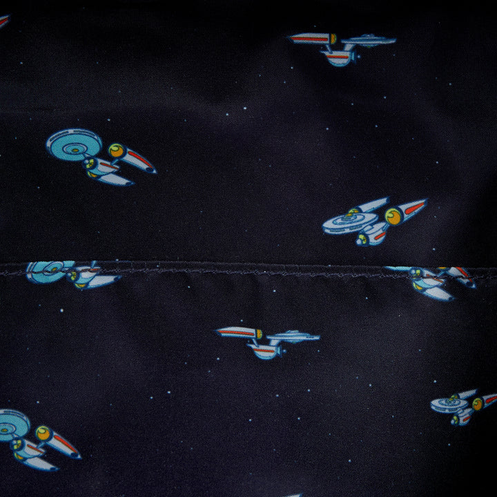 Pattern of space ships on a black fabric background
