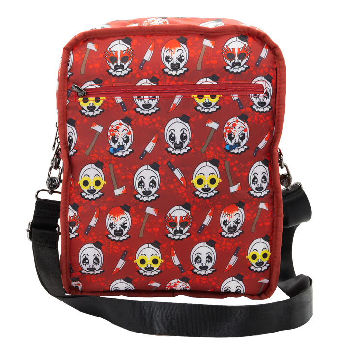 A red crossbody bag featuring a repeating horror clown and axe print, with a black adjustable strap and a front zippered pocket.