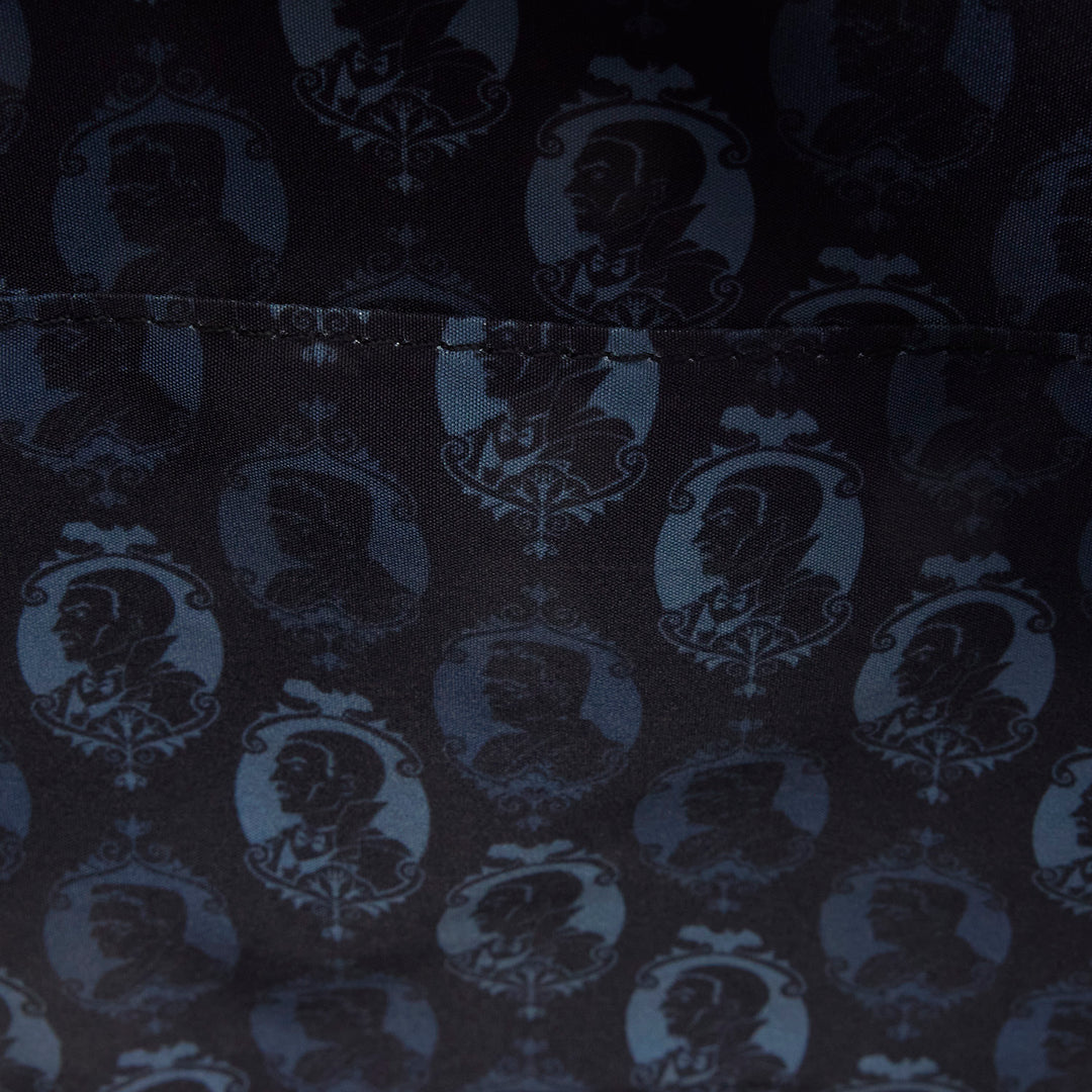 Dark fabric with a pattern of portraits in circular frames.