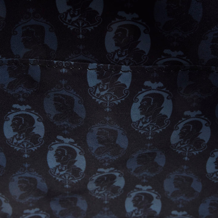Dark fabric with a pattern of portraits in circular frames.