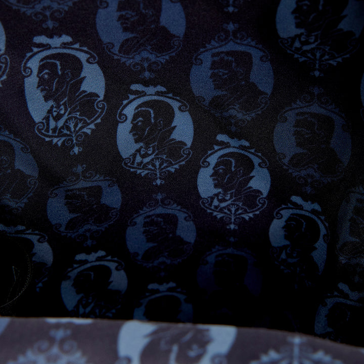 Dark fabric with silhouette patterns of faces and decorative elements