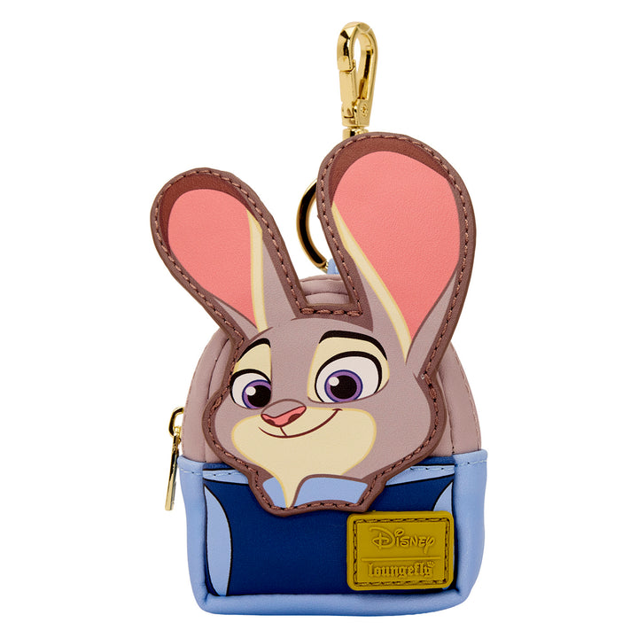 Character keychain with a smiling face, pink ears, and a blue pouch on a white background.