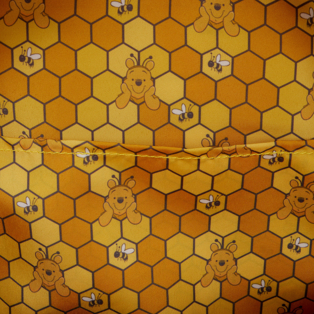 Fabric with honeycomb pattern featuring bears and bees on a yellow background