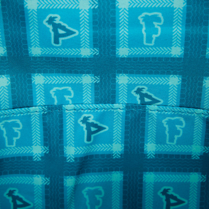 Close-up of blue fabric with geometric pattern and logo