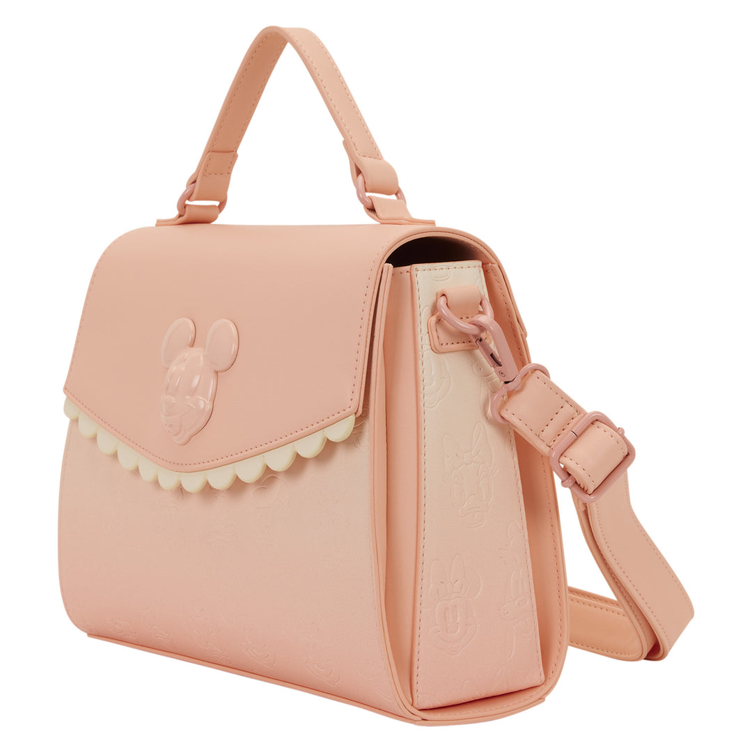 Pink handbag with a decorative flap on a white background