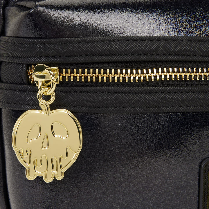 Gold skull charm on a black bag with gold zipper