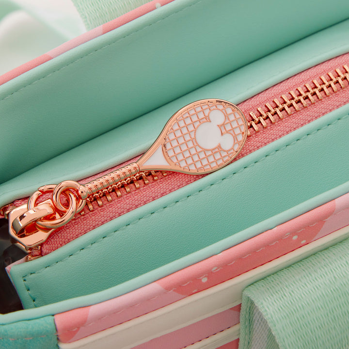 Close-up of a mint green and pink bag with a gold zipper featuring a Mickey Mouse design.