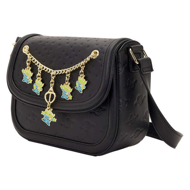 Black handbag with gold chain and character charms on a white background