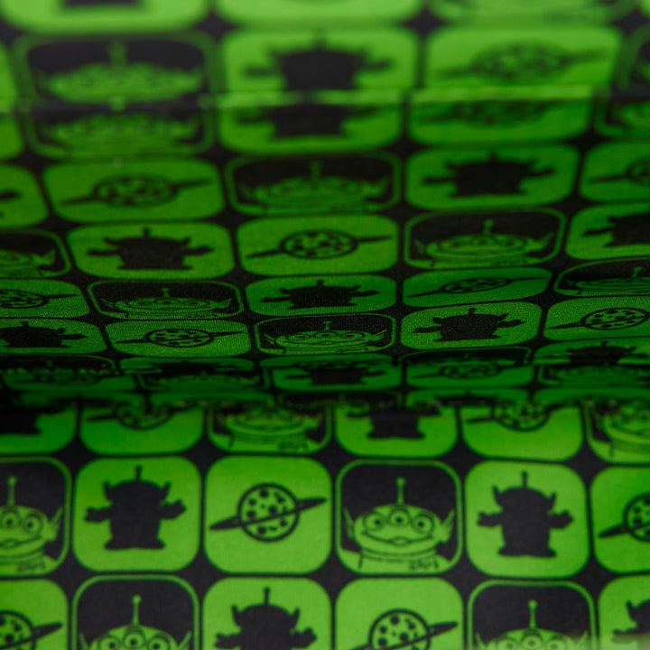 Patterned fabric with black symbols on a green background