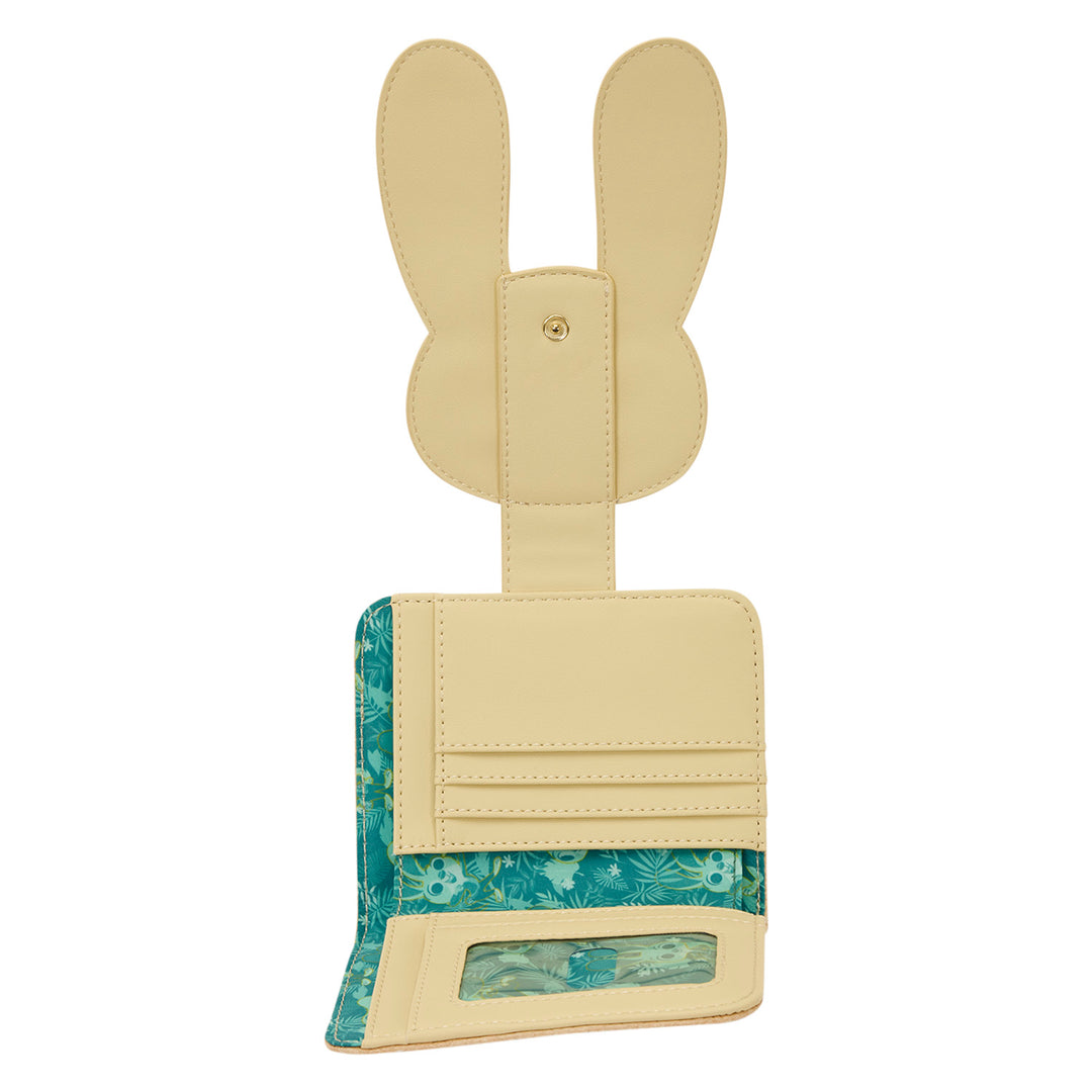 Beige bunny-shaped luggage tag with floral pattern on a white background