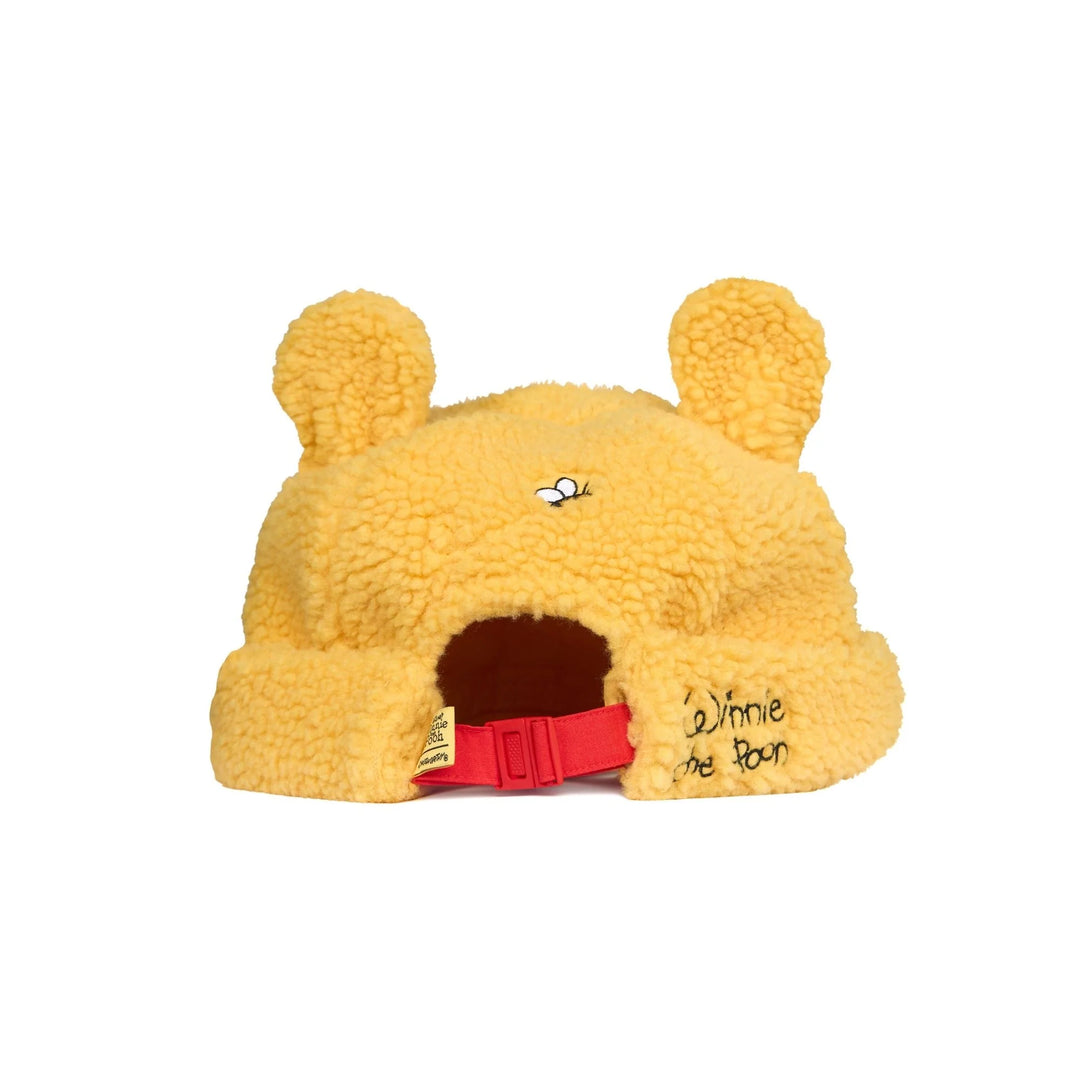 Yellow bear-shaped pet bed with red door and 'Winnie the Pooh' text on a white background