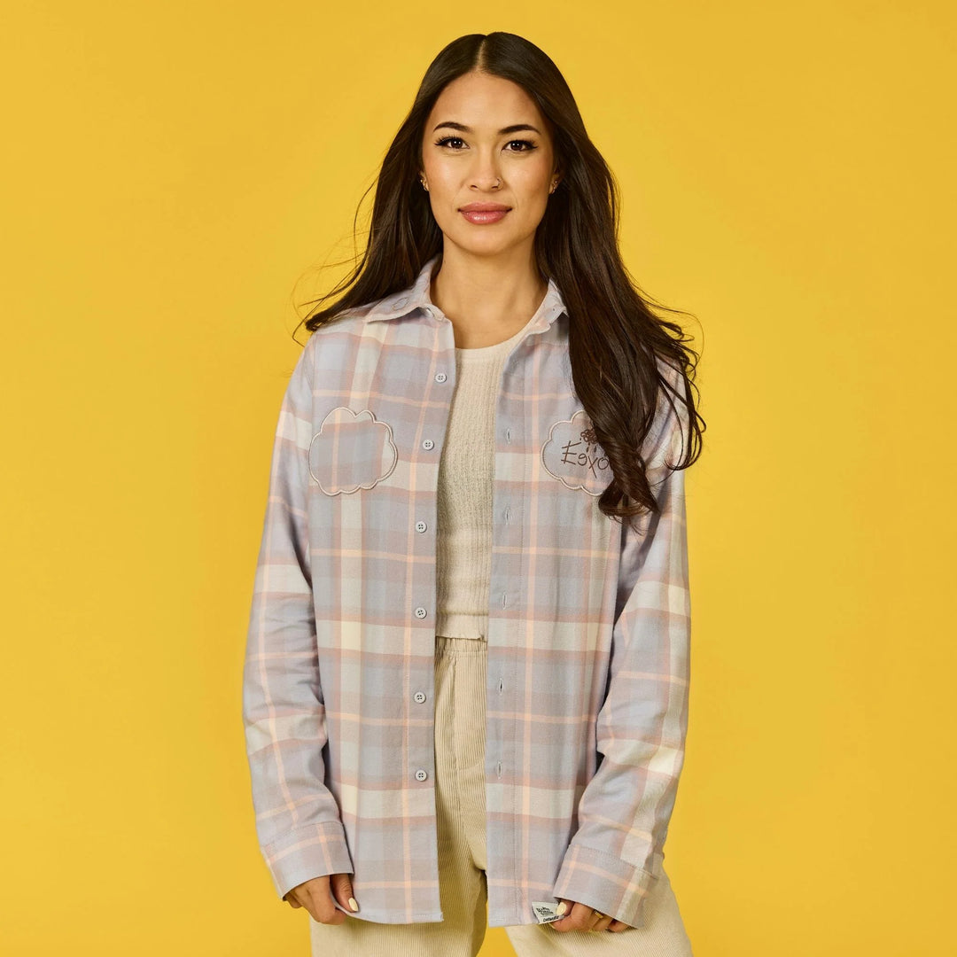 Woman wearing a plaid shirt on a yellow background