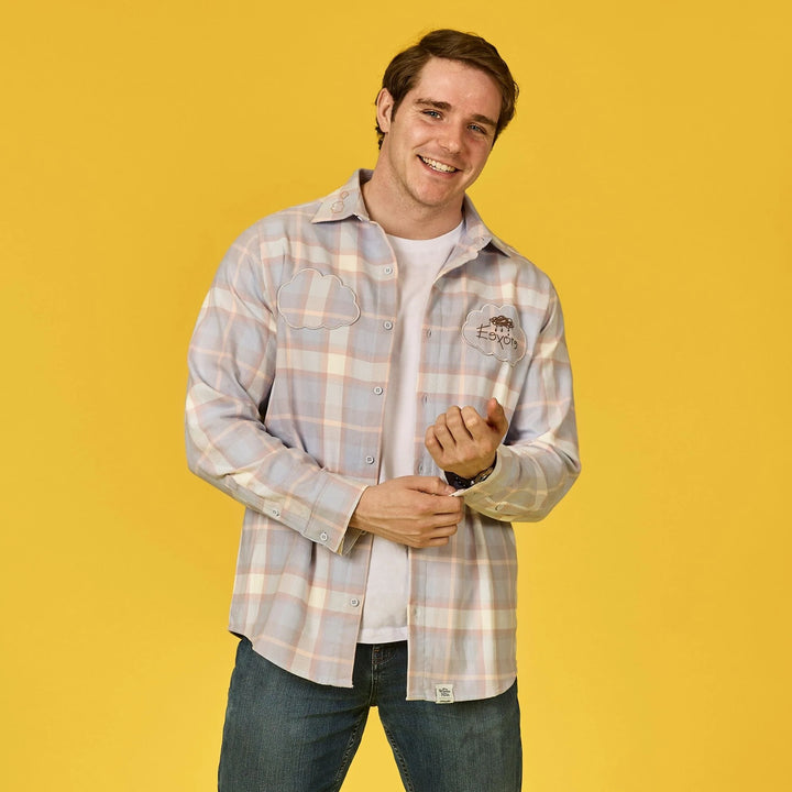 Man wearing a plaid shirt over a white t-shirt on a yellow background