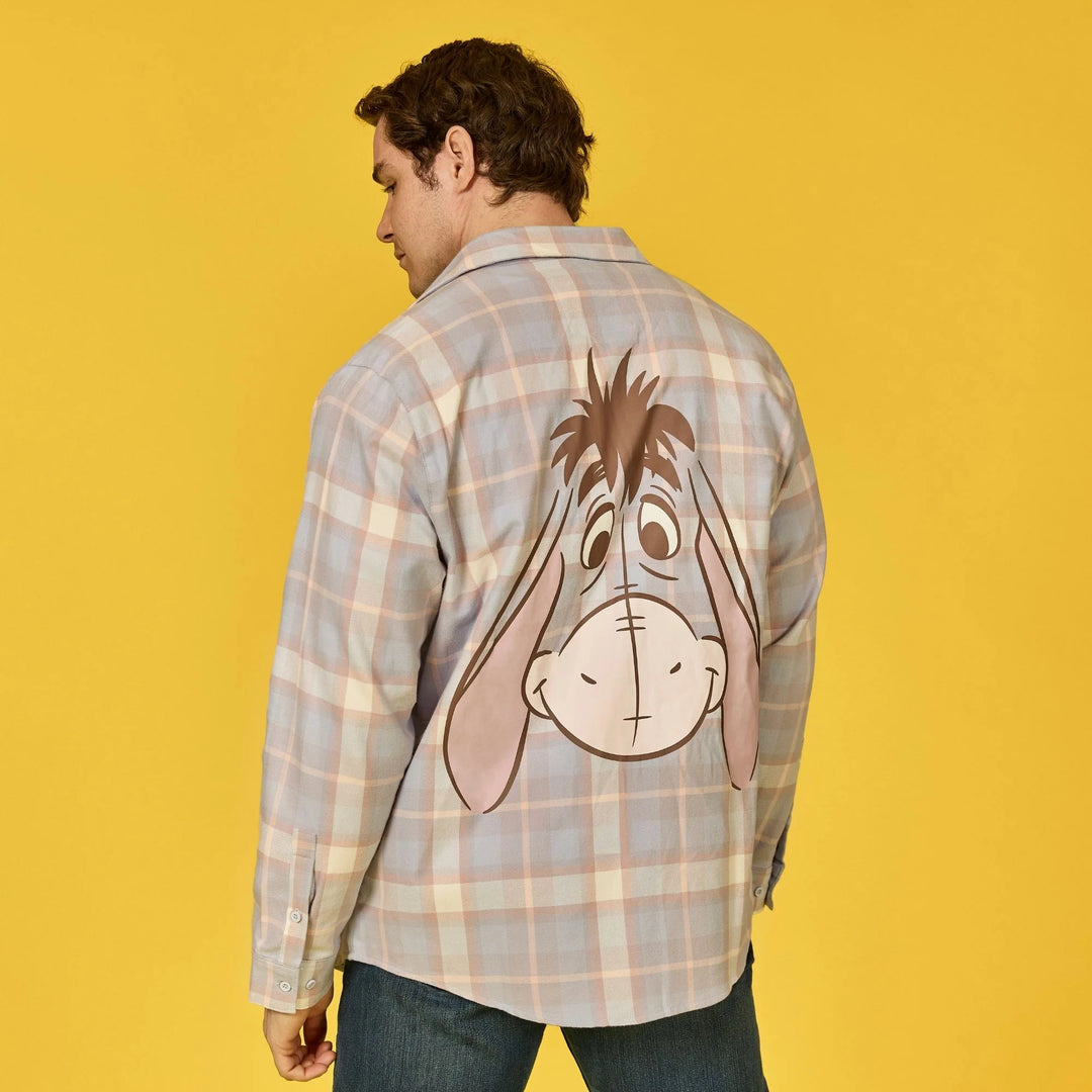 Person wearing a plaid shirt with a cartoon donkey design on a yellow background