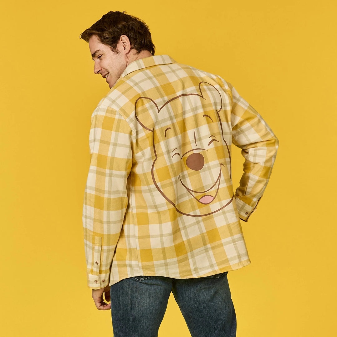 Person wearing a yellow plaid shirt with a cartoon character on a yellow background