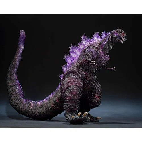 Monster toy with glowing purple spikes on a dark background
