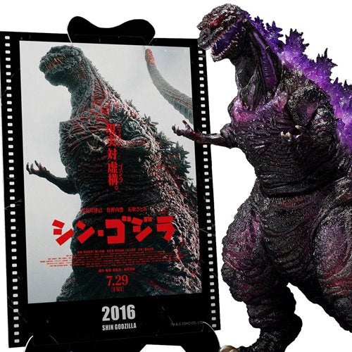 Godzilla figurine next to a movie poster for Shin Godzilla with Japanese text and release date.