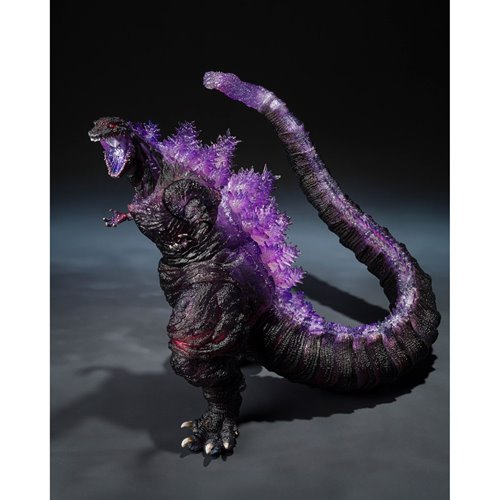 Monster toy figure with purple accents on a dark background